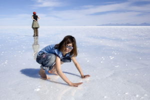 Giulia on wet Salar de Uyuni Bolivia Luca Galuzzi 2006